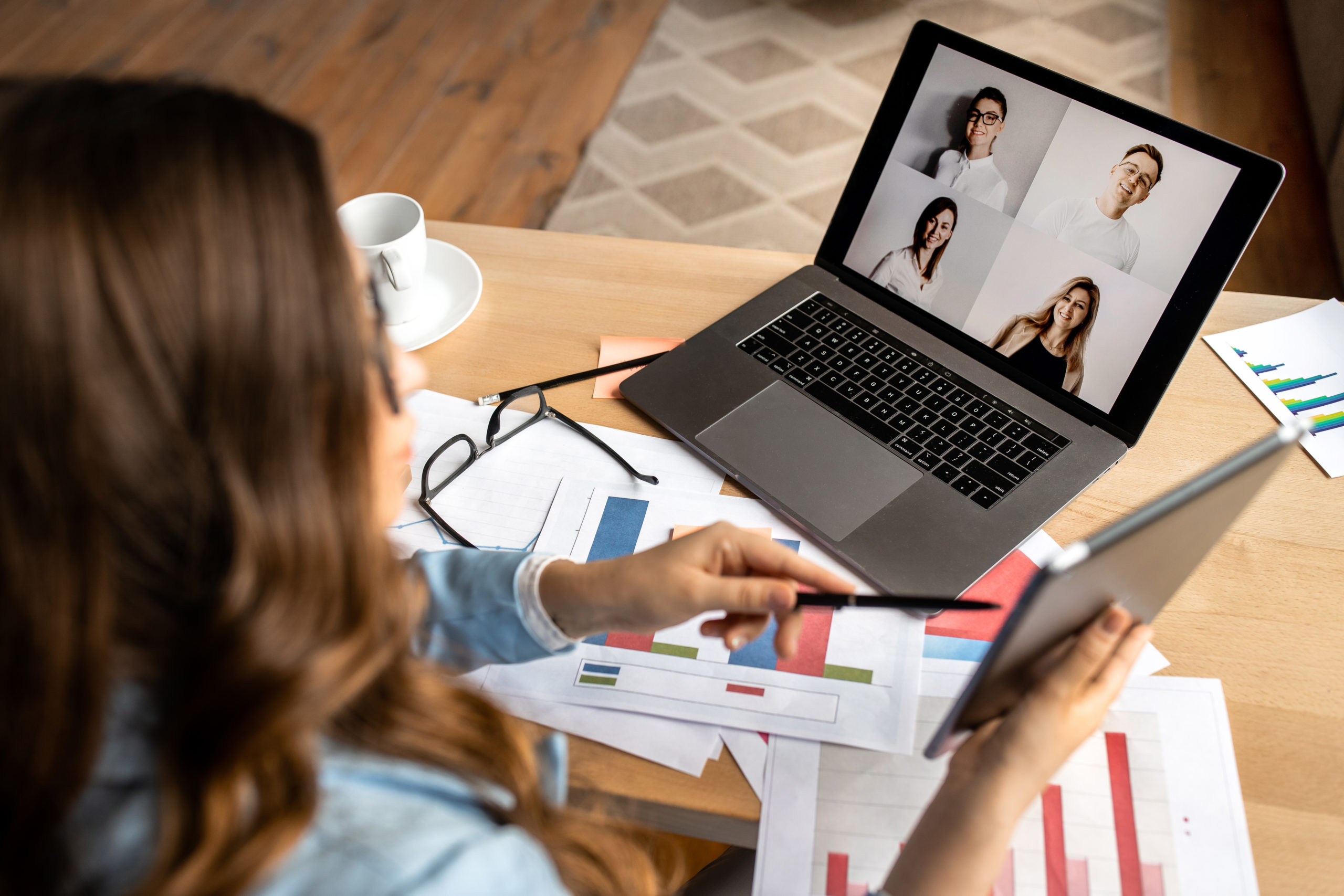 Woman presenting tablet on video conference